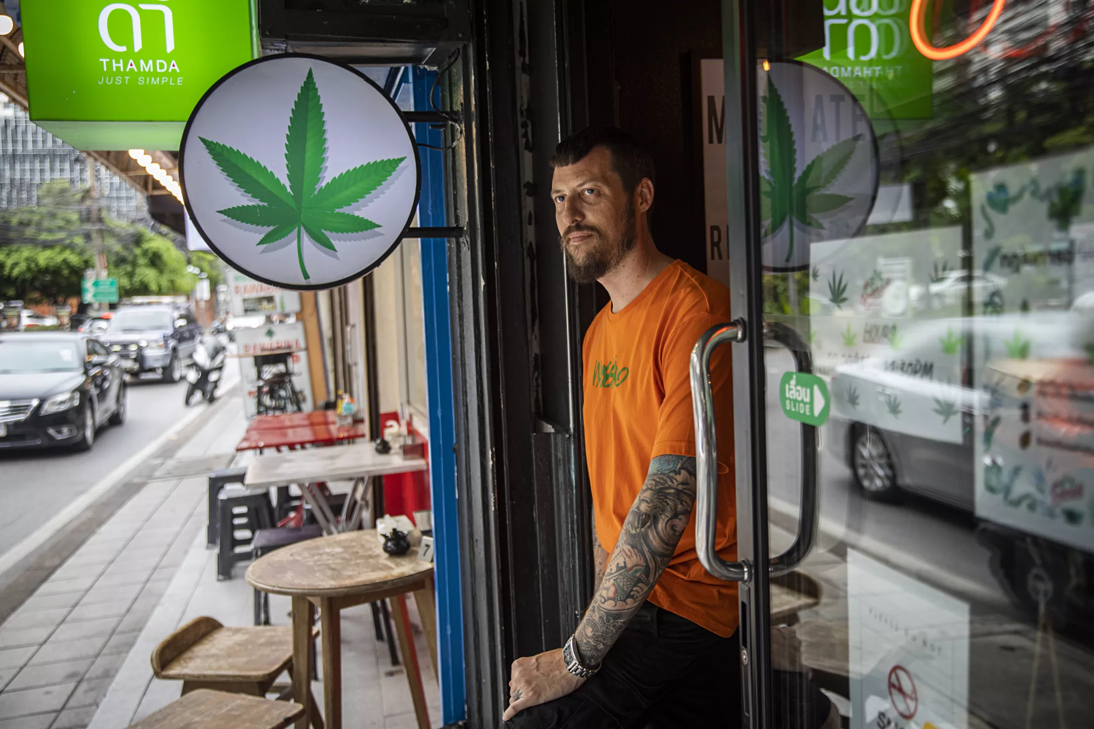 man walking out of cannabis dispensary