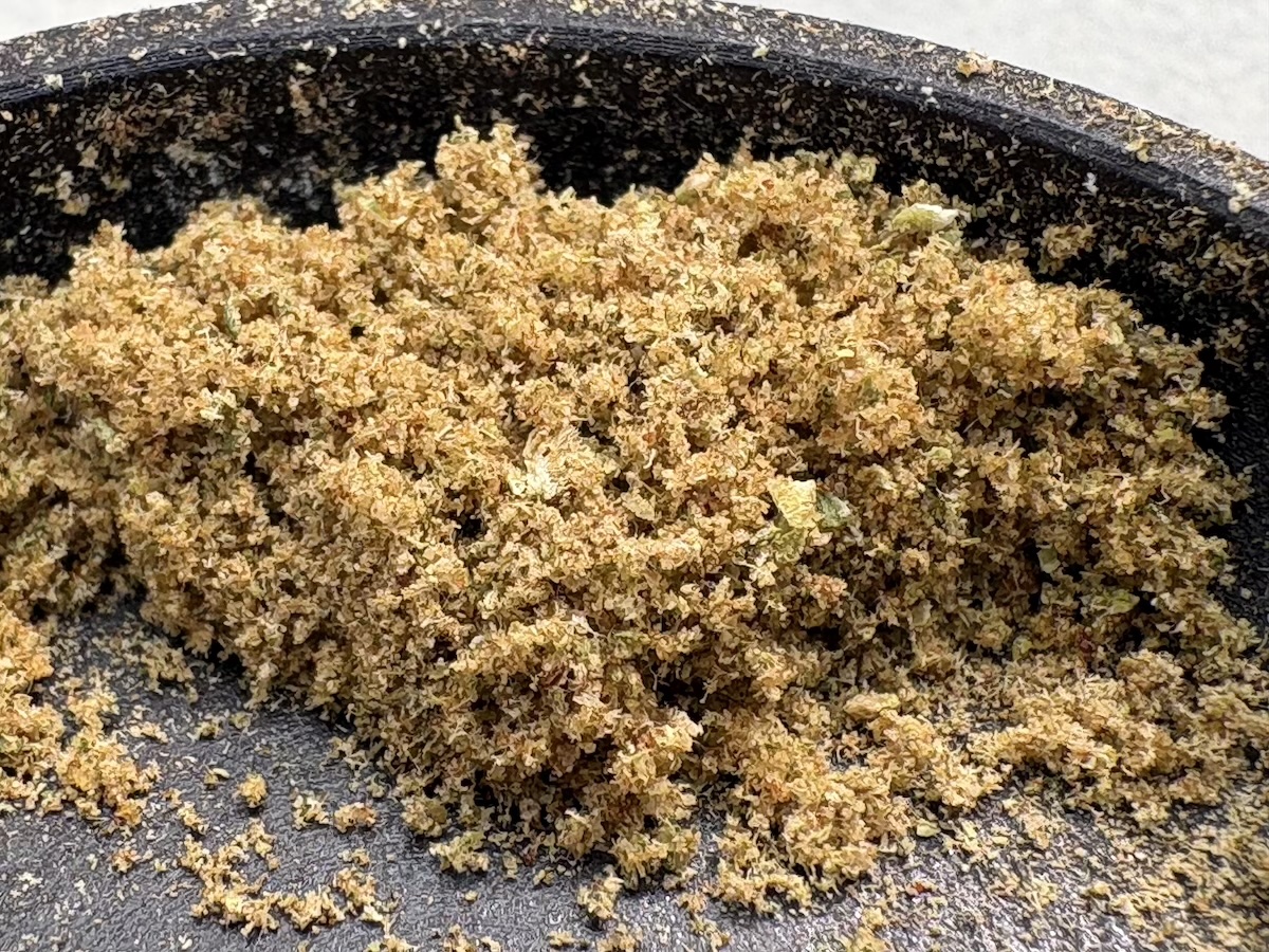fresh cannabis kief in bottom of grinder