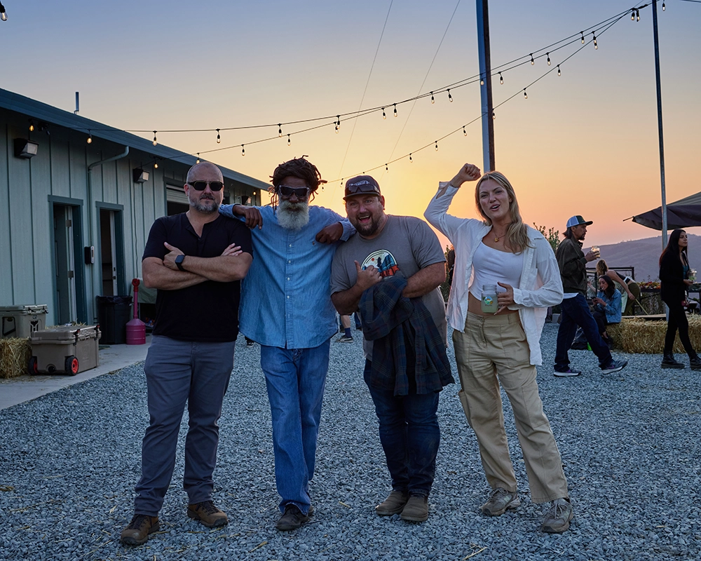 group of friends on cannabis farm at sunset