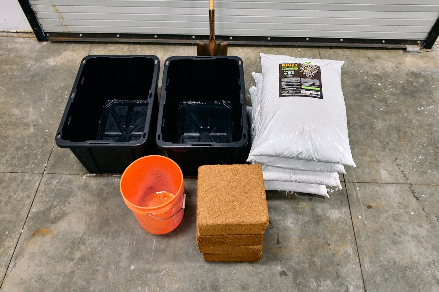 coco coir materials for cultivating cannabis including plastic bins, coco-coir, soil mix, and orange bucket