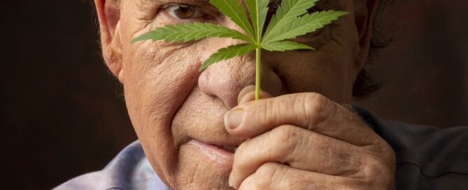 Ed Rosenthal holding a Cannabis Leaf in front of his face