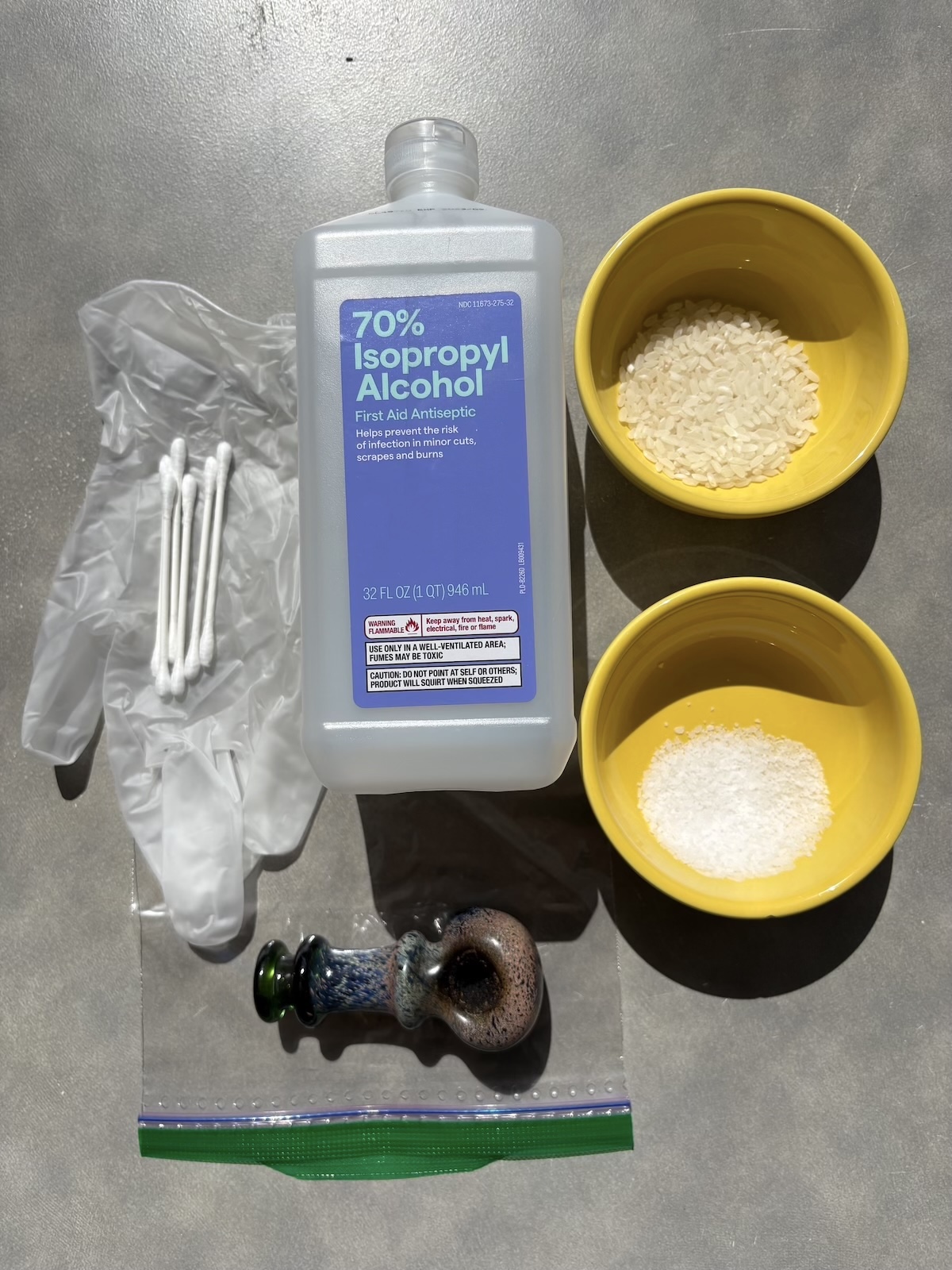 glass pipe cleaning materials: isopropyl alcohol, gloves, ziplock bag, rice, coarse salt, q tips, dirty pipe