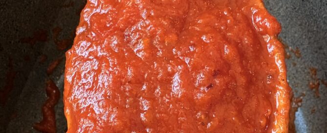 San Marzano Tomato Sauce on wooden spoon over pot