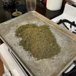 Ground cannabis on baking sheet for decarbing