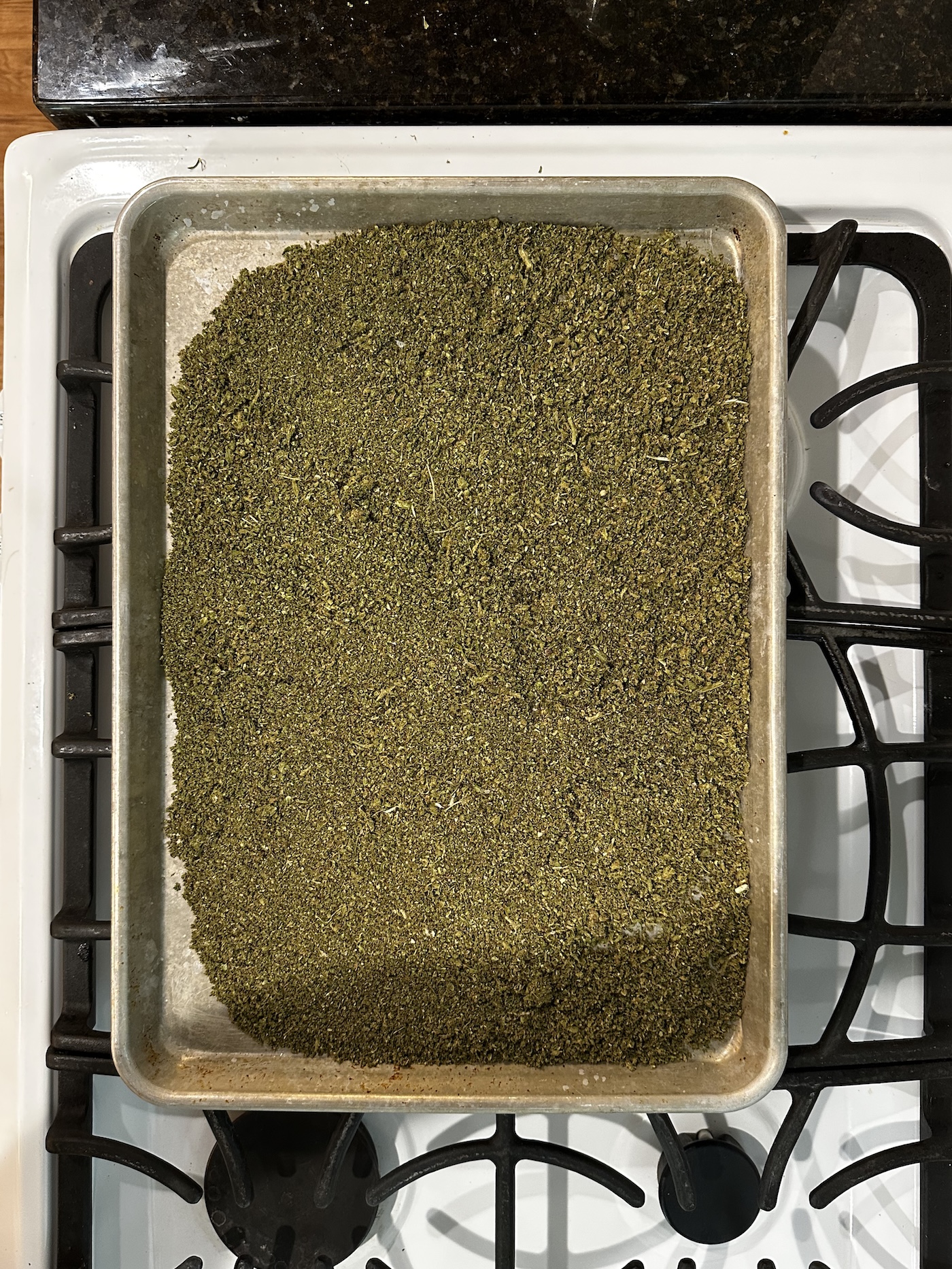ground cannabis on baking sheet for decarbing